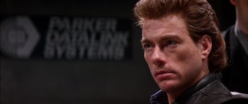 Movie still from “Timecop” (1994), directed by Peter Hyams – A man's face in front of a sign; Close Up shot, Low angle