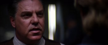 Movie still from “Timecop” (1994), directed by Peter Hyams – A man's face in front of a window; Close Up shot, Low angle