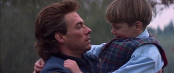 Movie still from “Timecop” (1994), directed by Peter Hyams – A man and a boy are looking into each others eyes; Close Up shot, Over the shoulder angle