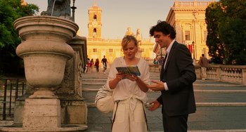 Movie still from “To Rome with Love” (2012), directed by Woody Allen – A man and a woman standing next to each other; Medium shot, Over the shoulder angle
