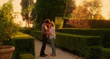 Movie still from “To Rome with Love” (2012), directed by Woody Allen – A man and a woman standing next to each other on a path; Wide shot, Low angle
