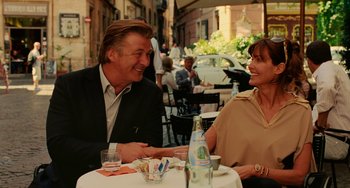 Movie still from “To Rome with Love” (2012), directed by Woody Allen – A man and a woman sitting at an outdoor table; Medium shot, Over the shoulder angle