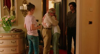 Movie still from “To Rome with Love” (2012), directed by Woody Allen – A group of people standing in a living room hugging; Wide shot, Over the shoulder angle