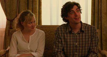 Movie still from “To Rome with Love” (2012), directed by Woody Allen – A man and a woman sitting next to each other on a couch; Close Up shot, Over the shoulder angle