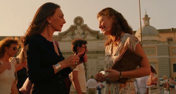 Movie still from “To Rome with Love” (2012), directed by Woody Allen – Two women talking to each other in front of a building; Medium shot, Over the shoulder angle