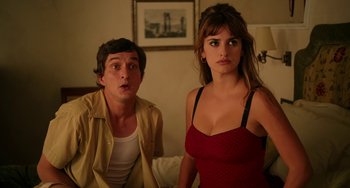 Movie still from “To Rome with Love” (2012), directed by Woody Allen – A man and a woman standing next to each other in a room; Medium shot, High angle