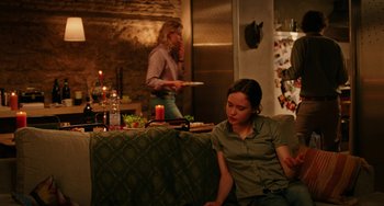 Movie still from “To Rome with Love” (2012), directed by Woody Allen – Two women are sitting in a kitchen and one of them is holding a plate; Medium shot, Over the shoulder angle