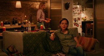 Movie still from “To Rome with Love” (2012), directed by Woody Allen – A man sitting on top of a couch next to a woman; Medium shot, Over the shoulder angle