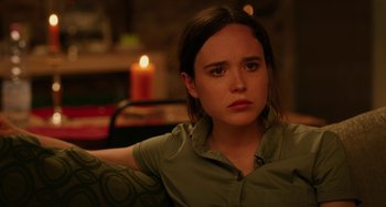 Movie still from “To Rome with Love” (2012), directed by Woody Allen – A woman sitting in front of a lit candle; Close Up shot, Over the shoulder angle