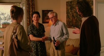 Movie still from “To Rome with Love” (2012), directed by Woody Allen – An older man and woman shaking hands in a living room; Medium shot, Over the shoulder angle