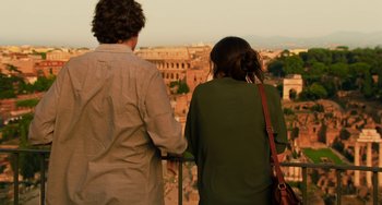 Movie still from “To Rome with Love” (2012), directed by Woody Allen – A man and a woman looking out over a city; Medium shot, Over the shoulder angle
