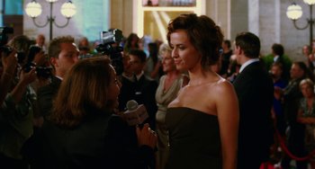Movie still from “To Rome with Love” (2012), directed by Woody Allen – A woman is being interviewed at a red carpet event; Medium shot, Over the shoulder angle