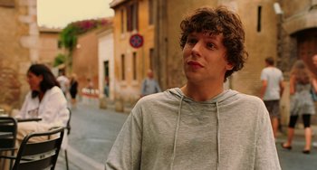 Movie still from “To Rome with Love” (2012), directed by Woody Allen – A young man standing on the side of the street; Close Up shot, Over the shoulder angle