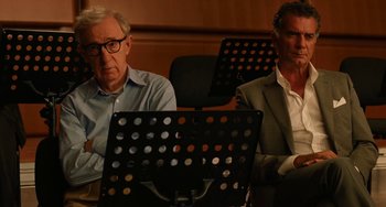 Movie still from “To Rome with Love” (2012), directed by Woody Allen – Two men sitting in front of a sheet music stand; Medium shot, Low angle