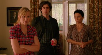 Movie still from “To Rome with Love” (2012), directed by Woody Allen – A group of people standing next to each other in a living room; Medium shot, Over the shoulder angle