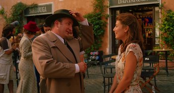 Movie still from “To Rome with Love” (2012), directed by Woody Allen – A man in a suit and a woman in a dress; Medium shot, Over the shoulder angle