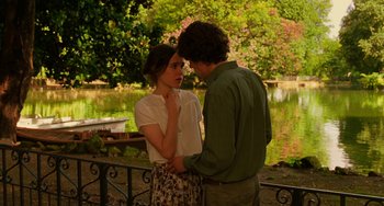 Movie still from “To Rome with Love” (2012), directed by Woody Allen – A man and a woman standing next to each other near a pond; Medium shot, Over the shoulder angle