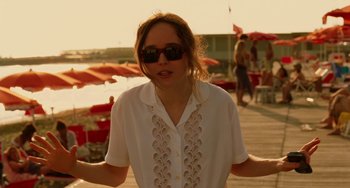 Movie still from “To Rome with Love” (2012), directed by Woody Allen – A woman wearing sunglasses and a white shirt; Medium shot, Over the shoulder angle