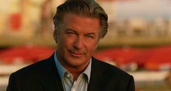 Movie still from “To Rome with Love” (2012), directed by Woody Allen – A person wearing a suit and tie; Close Up shot, Over the shoulder angle