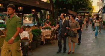 Movie still from “To Rome with Love” (2012), directed by Woody Allen – A man and a woman walking down a sidewalk; Wide shot, Over the shoulder angle