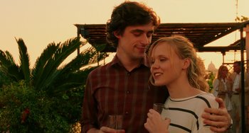 Movie still from “To Rome with Love” (2012), directed by Woody Allen – A man and a woman holding a wine glass; Medium shot, Over the shoulder angle