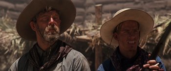 Movie still from “Tombstone” (1993), directed by George P. Cosmatos – Two men in cowboy hats and a cowboy hat; Close Up shot, Low angle