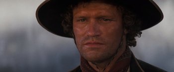 Movie still from “Tombstone” (1993), directed by George P. Cosmatos – A person wearing a cowboy hat; Close Up shot, Low angle