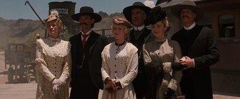 Movie still from “Tombstone” (1993), directed by George P. Cosmatos – A group of people standing next to each other wearing hats; Medium shot, Low angle