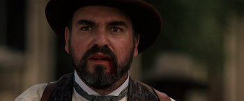 Movie still from “Tombstone” (1993), directed by George P. Cosmatos – A person wearing a hat; Close Up shot, Low angle