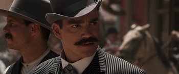 Movie still from “Tombstone” (1993), directed by George P. Cosmatos – A person wearing a top hat; Close Up shot, Low angle