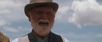Movie still from “Tombstone” (1993), directed by George P. Cosmatos – An old man with a beard wearing a hat and a vest; Close Up shot, Low angle