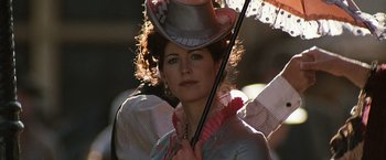Movie still from “Tombstone” (1993), directed by George P. Cosmatos – A woman holding a cane and wearing a top hat; Close Up shot, Low angle