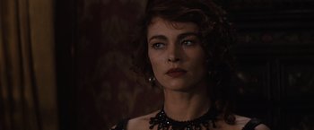 Movie still from “Tombstone” (1993), directed by George P. Cosmatos – A person wearing a necklace; Close Up shot, Over the shoulder angle