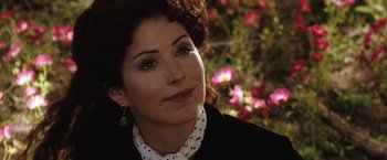 Movie still from “Tombstone” (1993), directed by George P. Cosmatos – A person wearing a suit and tie; Close Up shot, Over the shoulder angle