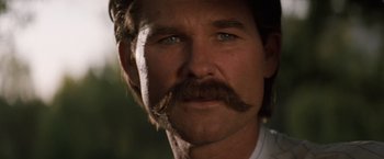 Movie still from “Tombstone” (1993), directed by George P. Cosmatos – A person with a mustache; Close Up shot, Low angle