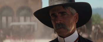 Movie still from “Tombstone” (1993), directed by George P. Cosmatos – An older man with a mustache wearing a hat; Close Up shot, Low angle