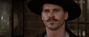 Movie still from “Tombstone” (1993), directed by George P. Cosmatos – A person wearing a hat; Close Up shot, Low angle