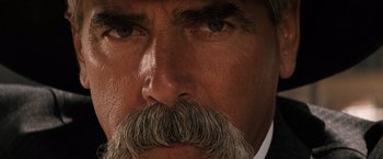 Movie still from “Tombstone” (1993), directed by George P. Cosmatos – A man's face with a mustache; Extreme Close Up shot, Low angle