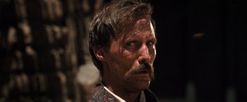 Movie still from “Tombstone” (1993), directed by George P. Cosmatos – A person with a mustache; Close Up shot, Low angle