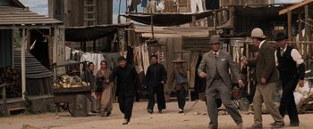 Movie still from “Tombstone” (1993), directed by George P. Cosmatos – A group of people walking down a street; Wide shot, Low angle
