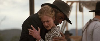 Movie still from “Tombstone” (1993), directed by George P. Cosmatos – A man and a woman embracing each other; Close Up shot, Low angle