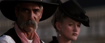 Movie still from “Tombstone” (1993), directed by George P. Cosmatos – A man and a woman wearing cowboy hats; Close Up shot, Low angle