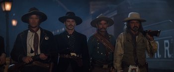 Movie still from “Tombstone” (1993), directed by George P. Cosmatos – A group of men standing next to each other wearing hats; Medium shot, Low angle