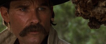 Movie still from “Tombstone” (1993), directed by George P. Cosmatos – A person wearing a cowboy hat; Close Up shot, Low angle