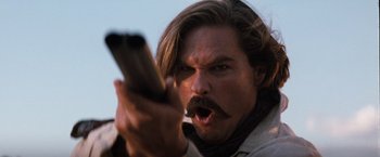 Movie still from “Tombstone” (1993), directed by George P. Cosmatos – A person holding a cell phone; Close Up shot, Low angle