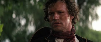 Movie still from “Tombstone” (1993), directed by George P. Cosmatos – A person with curly hair; Close Up shot, Low angle