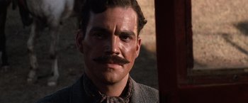 Movie still from “Tombstone” (1993), directed by George P. Cosmatos – A person with a mustache; Close Up shot, Low angle