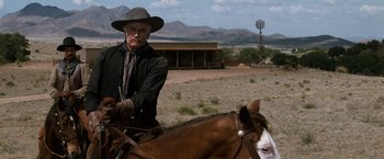 Movie still from “Tombstone” (1993), directed by George P. Cosmatos – An old man on a horse in the middle of the desert; Medium shot, Low angle
