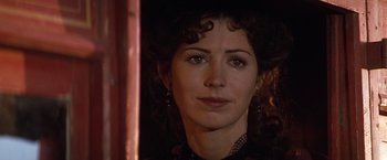 Movie still from “Tombstone” (1993), directed by George P. Cosmatos – A person with curly hair; Close Up shot, Over the shoulder angle