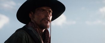 Movie still from “Tombstone” (1993), directed by George P. Cosmatos – A person wearing a cowboy hat; Close Up shot, Low angle